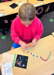 5th_girlmkingelktoothecklaceWES Elk Tooth Necklaces Project